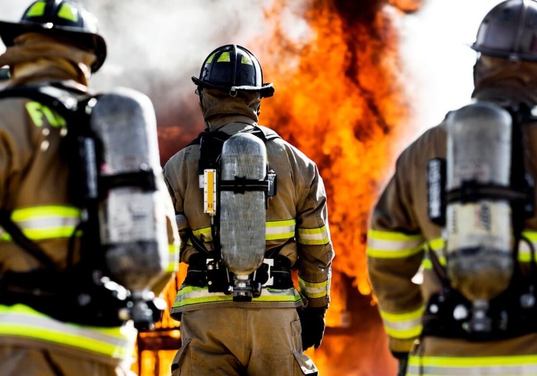 A group of firefighters standing next to each other.